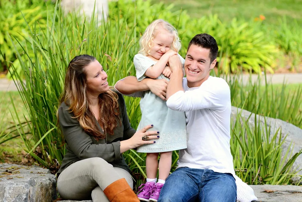 Erik Bye with his wife Jaime and their daughter Ellie, outdoors on a summer day